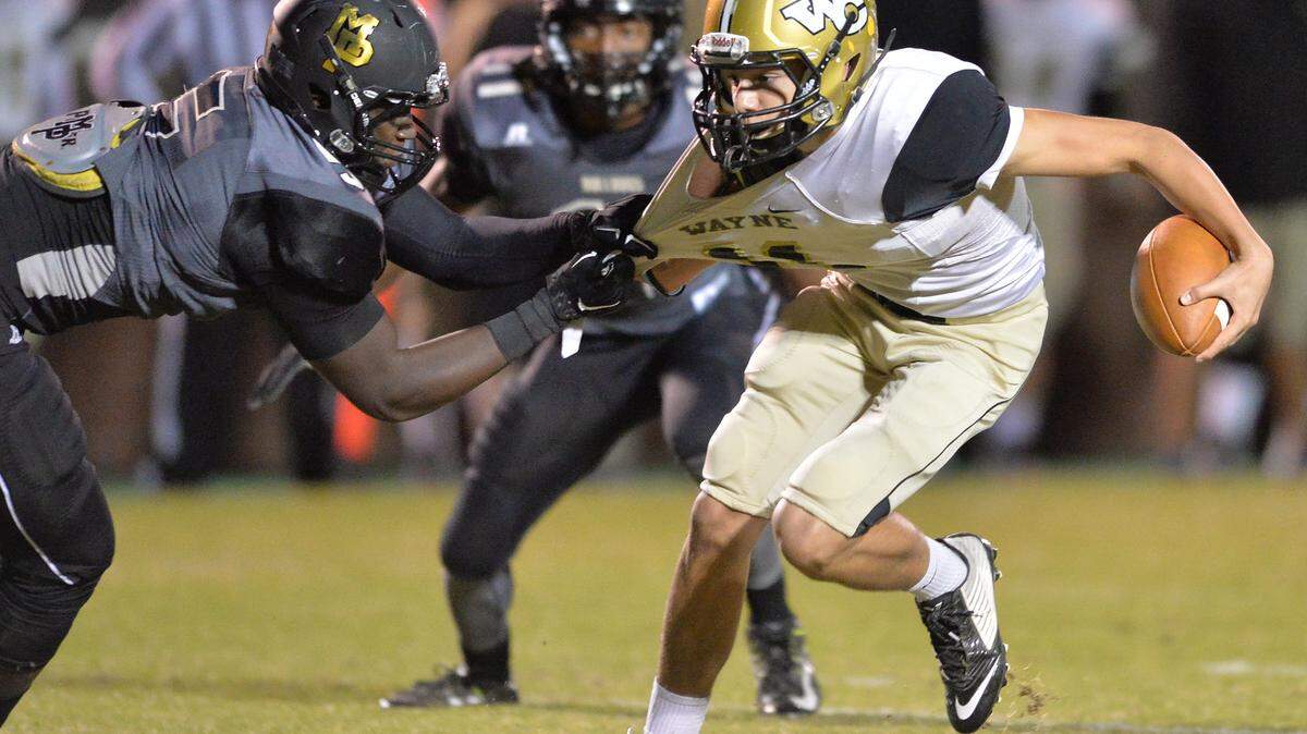 Wayne County quarterback Nolan Grooms, right, is sacked by Mary Persons' Malik Herring during last week's GHSA Class AAAA first-round playoff game.