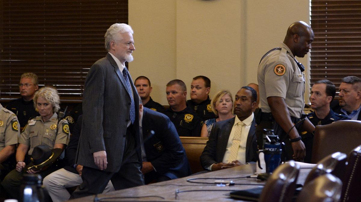 Ralph Stanley Elrod Jr., at left, makes his way into a Peach County Superior Court on Thursday, where he agreed to plead guilty in the shooting deaths of deputies Daryl Smallwood and Patrick Sondron.