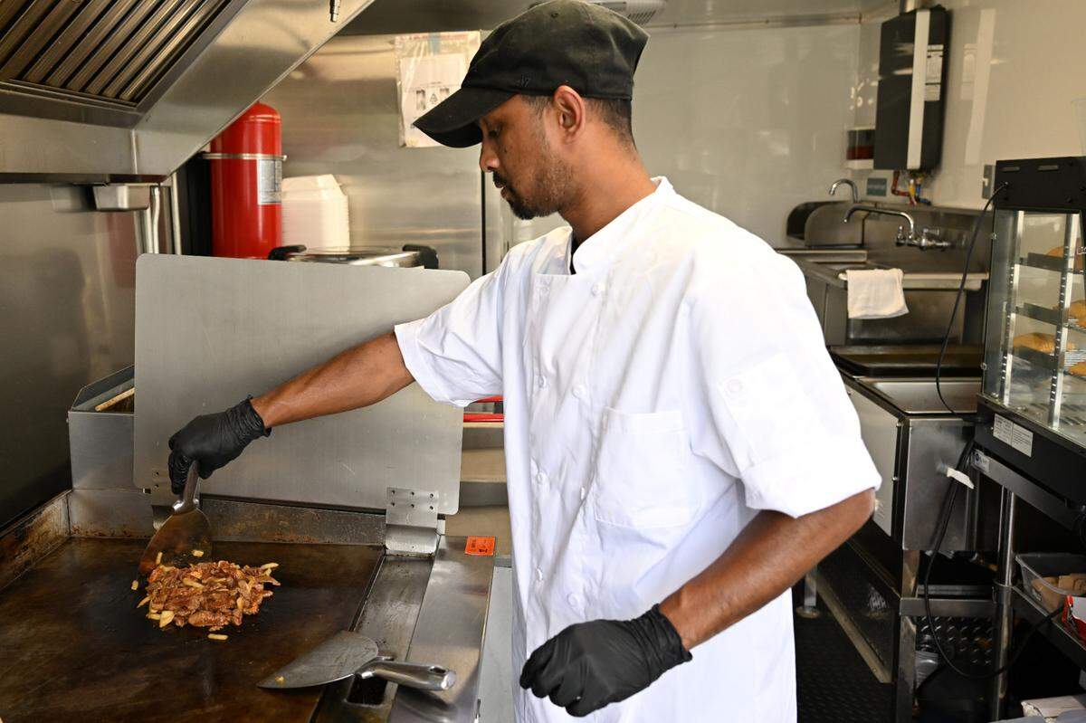______ prepares a lamb wrap on Tuesday, April 22, 2025, in Macon, Georgia. Macon Halal Eats sits off of Forest Hills Road. 