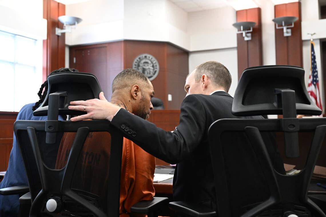 Attorney Michael Admirand (right) speaks with Jessie Askew ahead of his hearing on Friday, April 24, 2026, at the Houston County Superior Courthouse in Perry, Ga. 