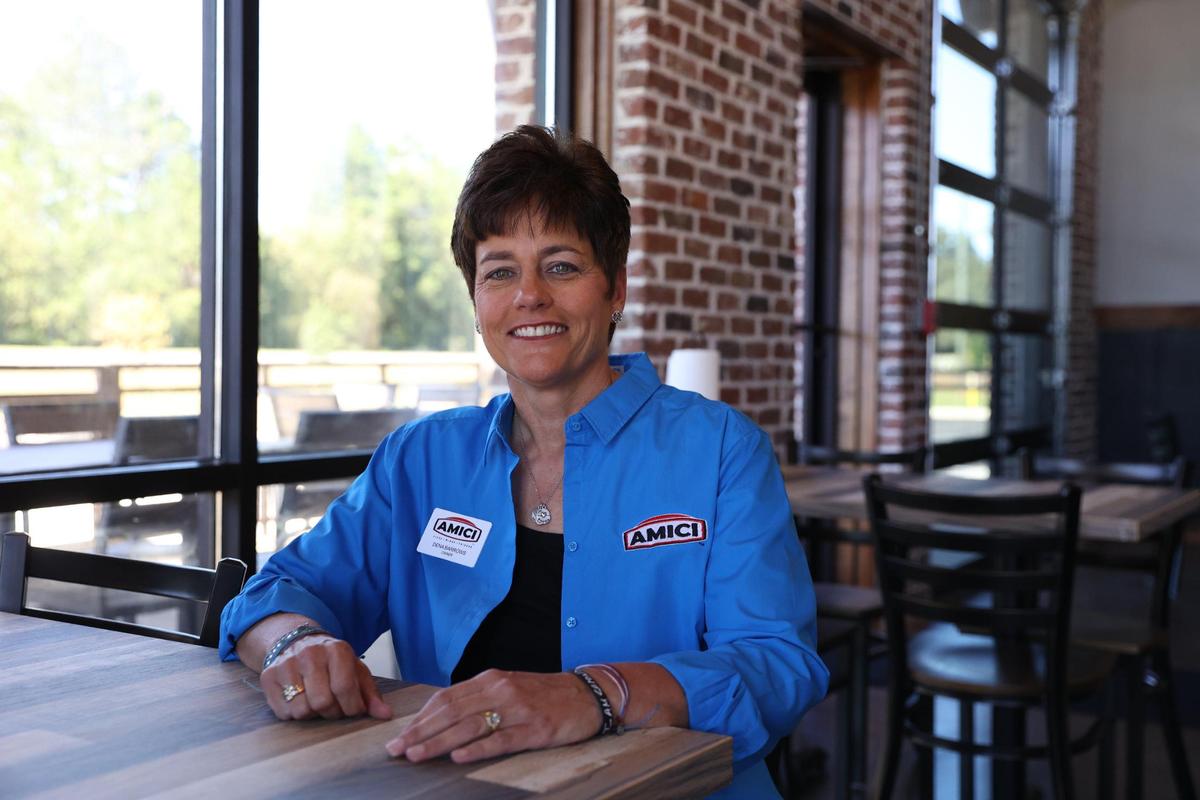 Owner of the Perry location of Amici Deena Barrows poses inside of the restaurant on Wednesday, Oct. 16, 2024, in Perry, Georgia. Barrows hopes that Amici, which opens Monday, will become “the living room of Perry.”