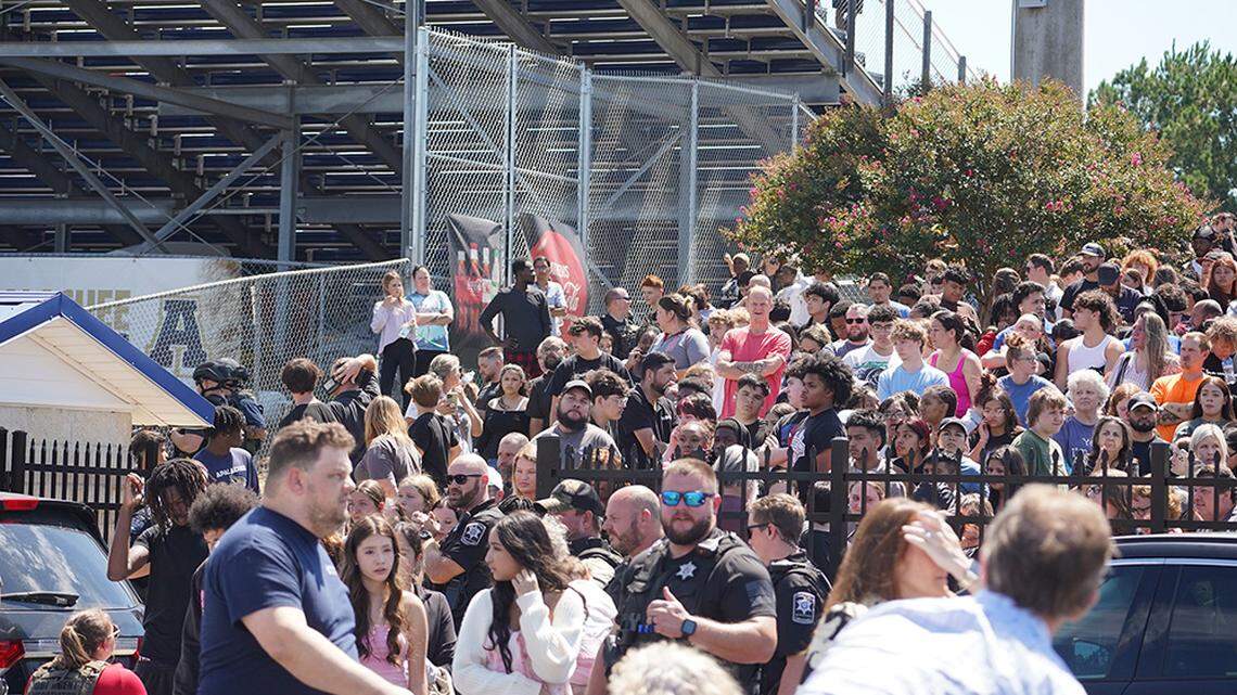 Students wait to be picked up by their parents after a shooting at Apalachee High School in Winder, Ga., on Wednesday. A 14-year-old boy was in custody after two students and two teachers were killed and nine others wounded, authorities said.