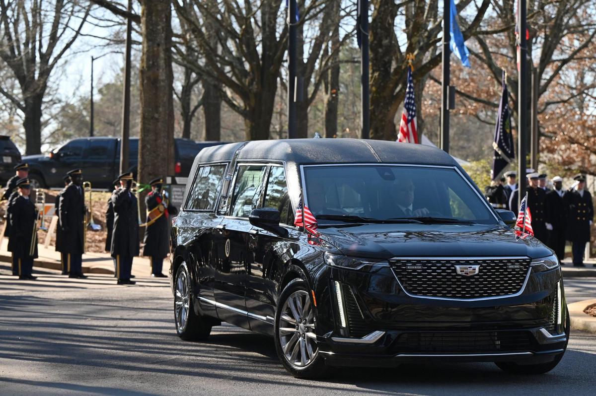 The hearse carrying former president Jimmy Carter departs the Carter Presidential Center on Tuesday, Jan. 7, 2024, at the Carter Presidential Center in Atlanta, Georgia. The Carter hearse and motorcade left the Carter Presidential Center and drove to Dobbins Air Reserve to fly to Washington D.C., where the former president will lie in state at the U.S. Capitol until Thursday.