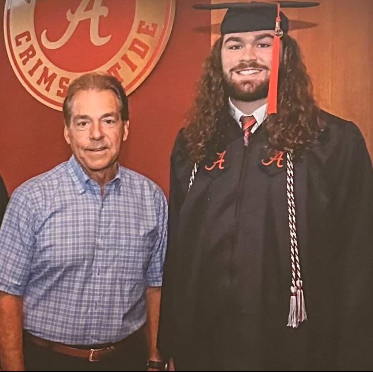 Giles Amos smiles for a photo with University of Alabama head coach Nick Saban following graduation. Amos is opening D1 Training in Macon this month.