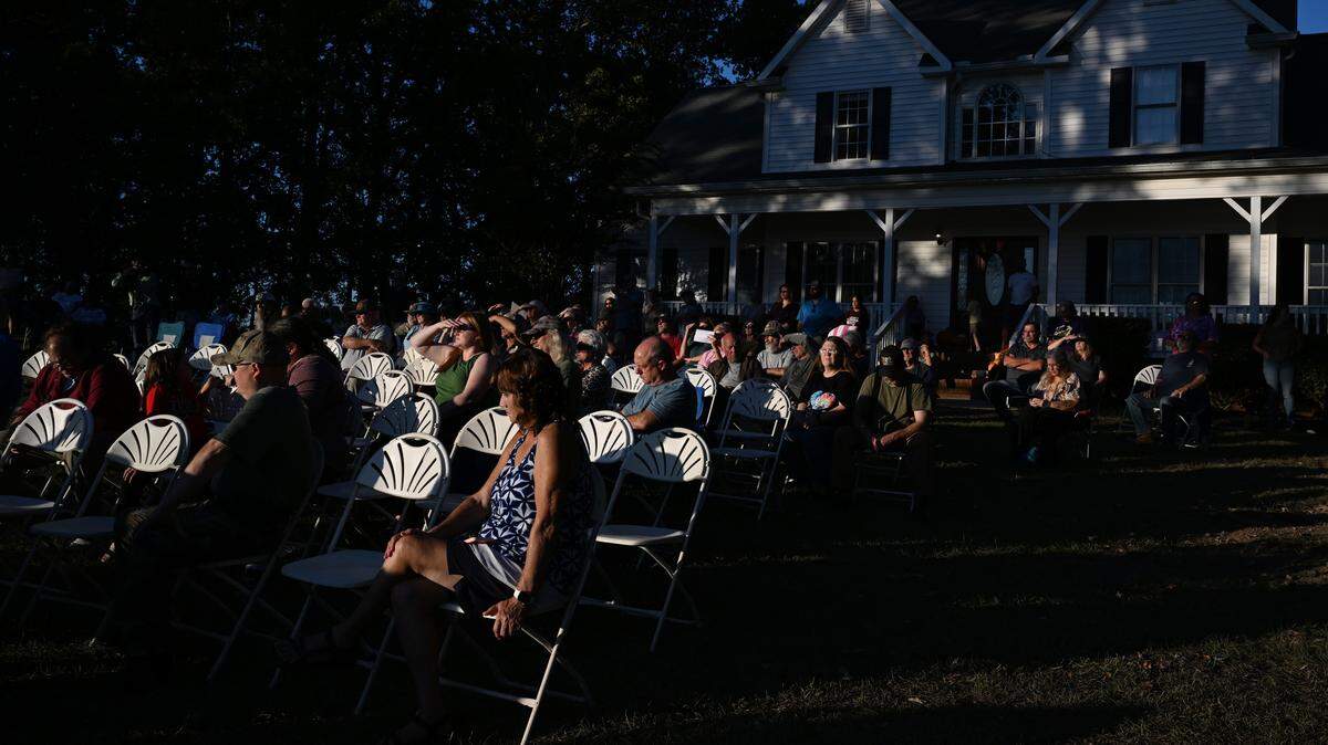Concerned Jones County residents sit in folding chairs in the front yard of organizer Alex Lefholz during a Jones County data center informational meeting on Wednesday, Oct. 15, 2025, in Gray, Georgia. County residents and advocates met ahead of the Jones County Planning and Zoning meeting that is set to discuss rezoning agricultural land to commercial for a potential data center.  
