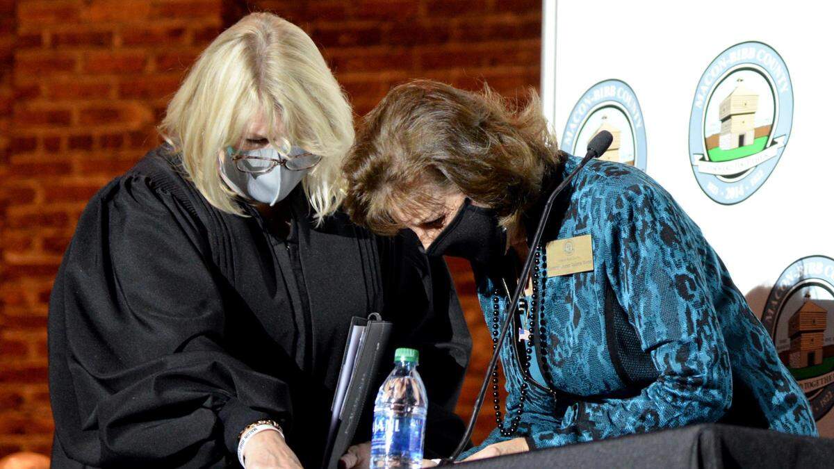 Macon-Bibb County Commissioner Valerie Wynn signs documents after being sworn into office at the Inauguration Ceremony at the Macon City Auditorium on Dec. 30, 2020.