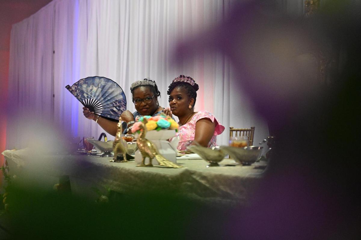 Maya Johnson (left), from Augusta, Georgia, and Salena Boye, from Bonaire, Georgia, sit at the end of the queen’s table at Queen Elizabeth’s Royal Ball at the Anderson Conference Center on Saturday, April 26, 2025, in Macon, Georgia. Guests dressed in regency era ballgowns and suits at the event inspired by the hit Netflix series “Bridgerton.”