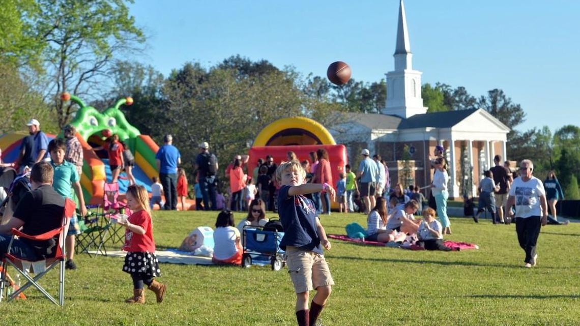 Braxton Lovett, 6, fires a pass as he and family members picnicked and waited for the fireworks show during the 2016 Cherry Blossom Festival finale at Wesleyan College.