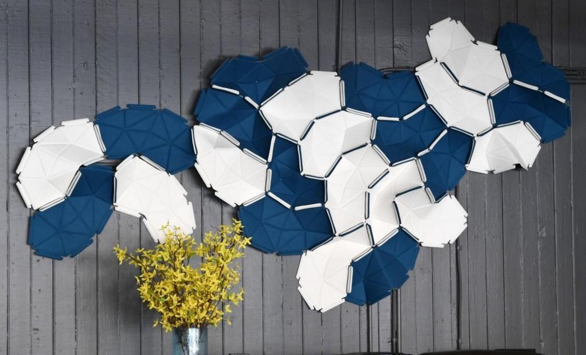 An abstract collage of textile art that cleverly combines the use of art and science for sound absorption.
