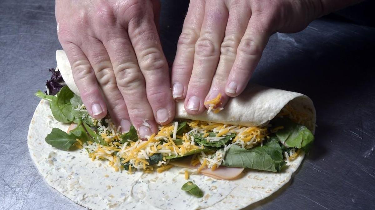 Teddi Wohlford rolls the wrap.