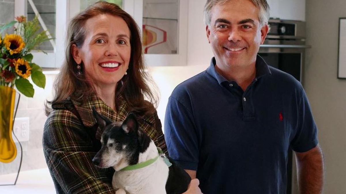 Siblings Melissa and Adam Oszustowicz with Patch, one of their dogs, in their new kitchen.
