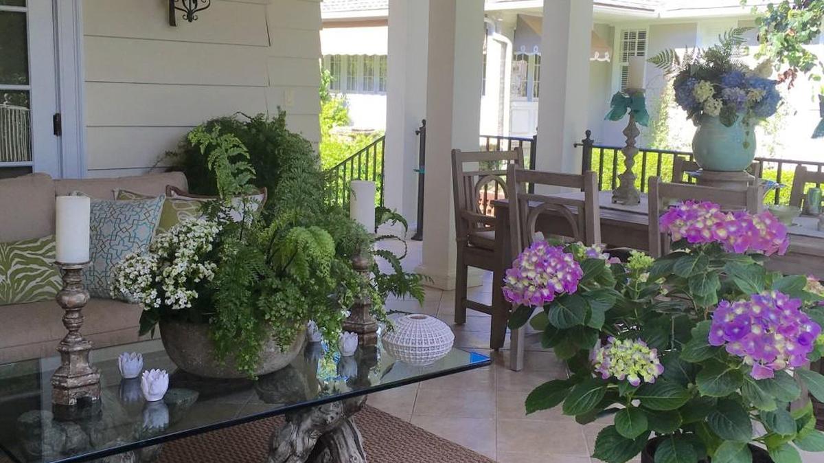 There is a profusion of color on the porch overlooking the garden at the home of Susie and Richard Guerreiro.