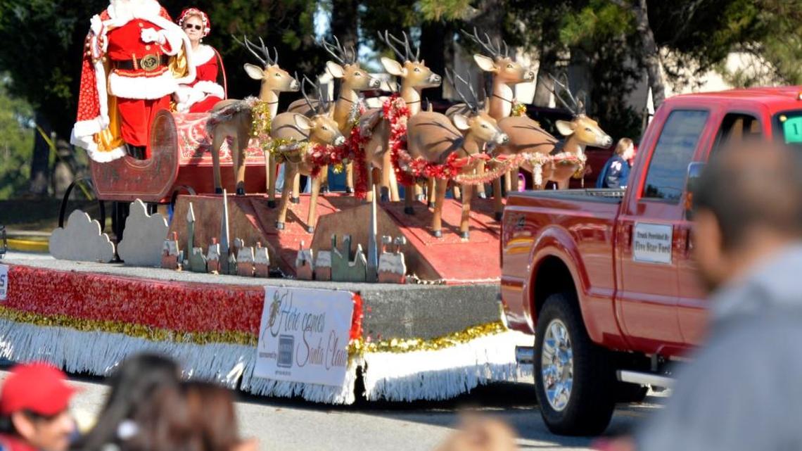 Santa and Mrs. Claus wave at onlookers along S. Davis Drive in Warner Robins during the 2015 Christmas parade.