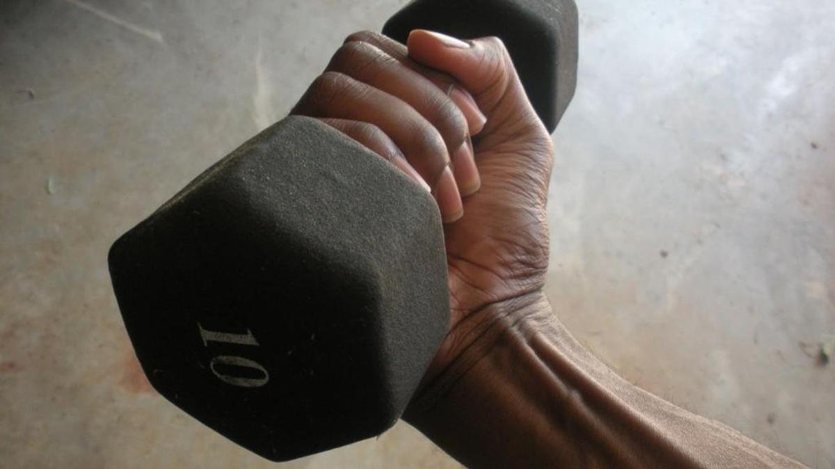 If you need to use the lighter weight, use it. You're in the gym to maintain your health, and not to impress anyone.