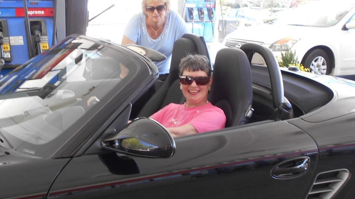 Mrs. Cool Kid, seated, and her friend Sue Anne the soon-to-be reader, like to ask strangers at gas stations if they can pose for pictures in their sports cars.