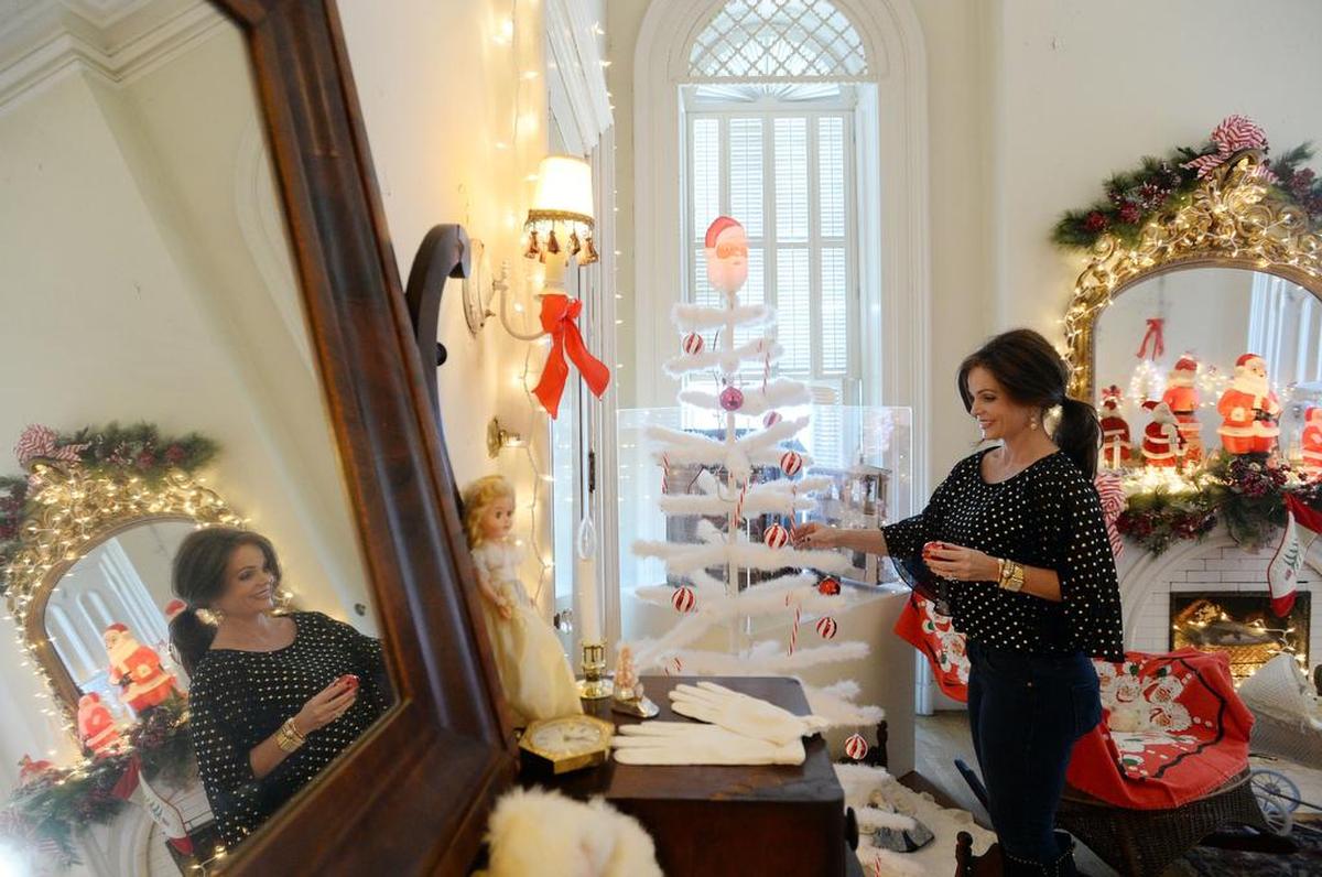 Jennifer Hayslip adds ruby glass ornaments to white tree in children's room.