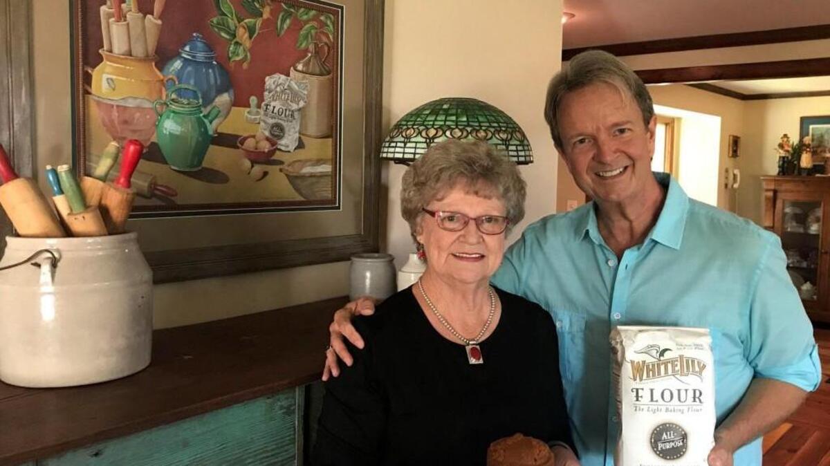Mark Ballard poses for a photo with Jimmie Lee Davis in front of the painting Ballard created for her.