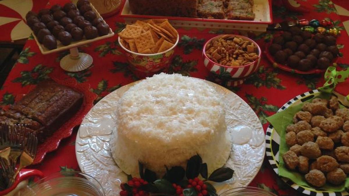 A table full of sweets with the all important coconut cake as a centerpiece.