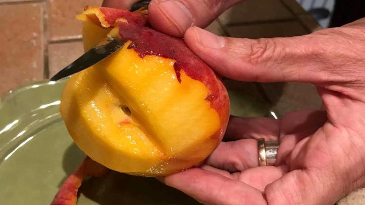 Mark Ballard peels a peach, getting to what’s most important: the inside.