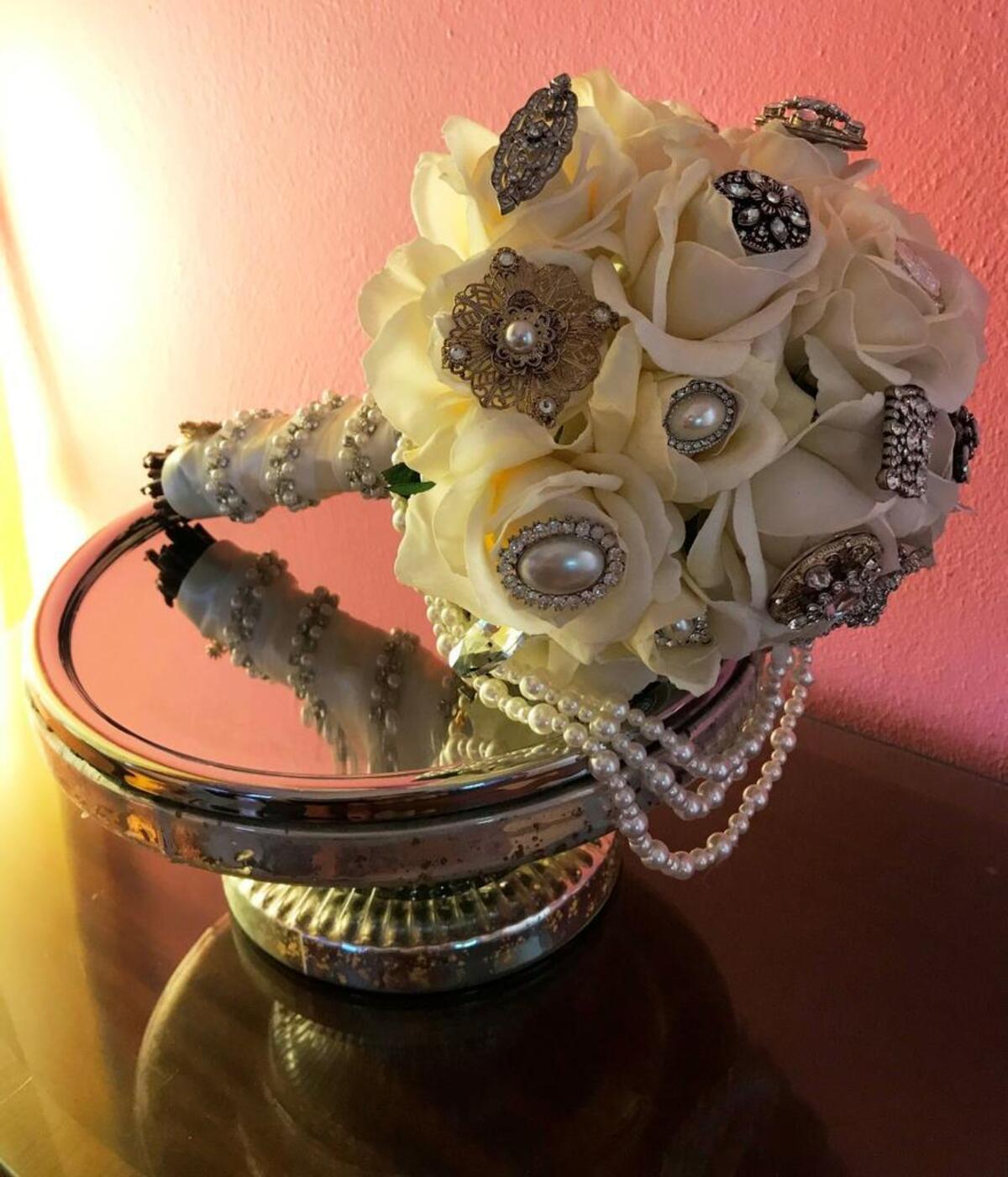 A bouquet made by Mark Ballard sits on a mercury glass cake stand.