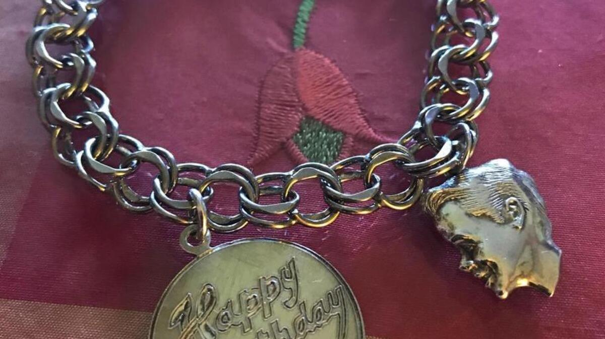Mark Ballard divided up the charms on his Mother’s charm bracelet with his sister.