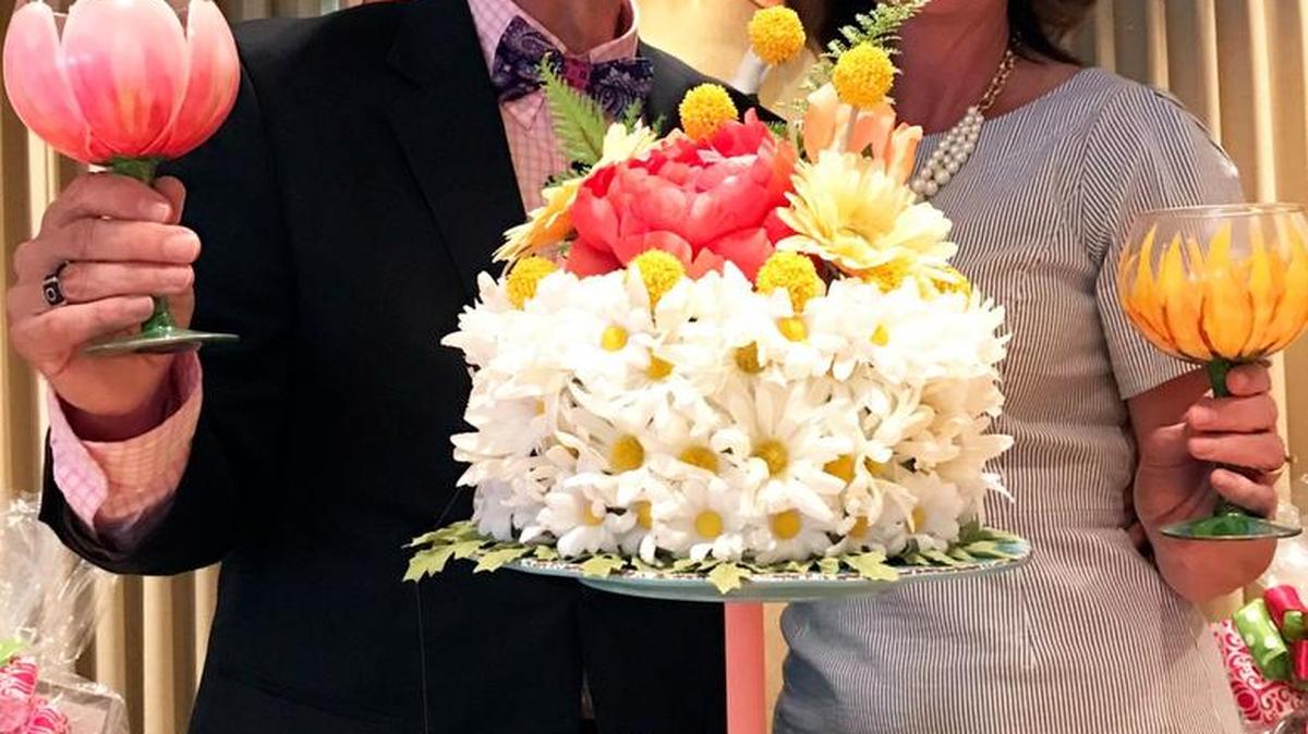 Mark Ballard and Susan Jarrard, wife of Maj. Gen. Joe Jarrard, adjutant general of Georgia National Guard, pose with his make-it-work cake plate and flower cake.