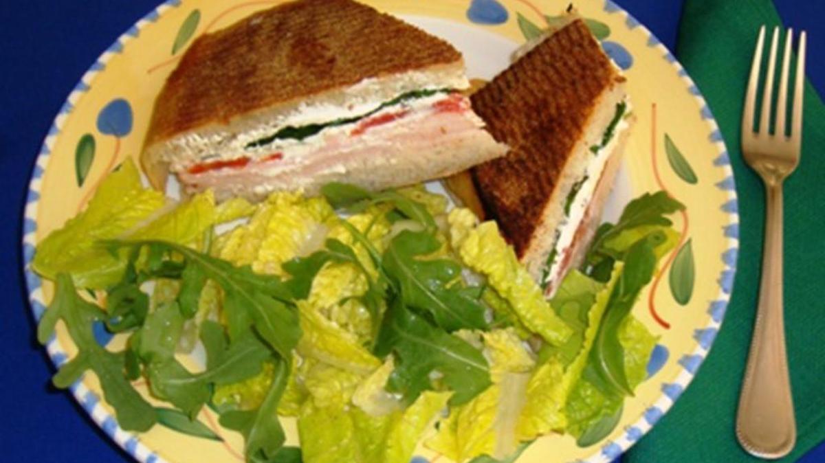 This Smoked Turkey and Cheese Panini is served with Italian Arugula Salad.