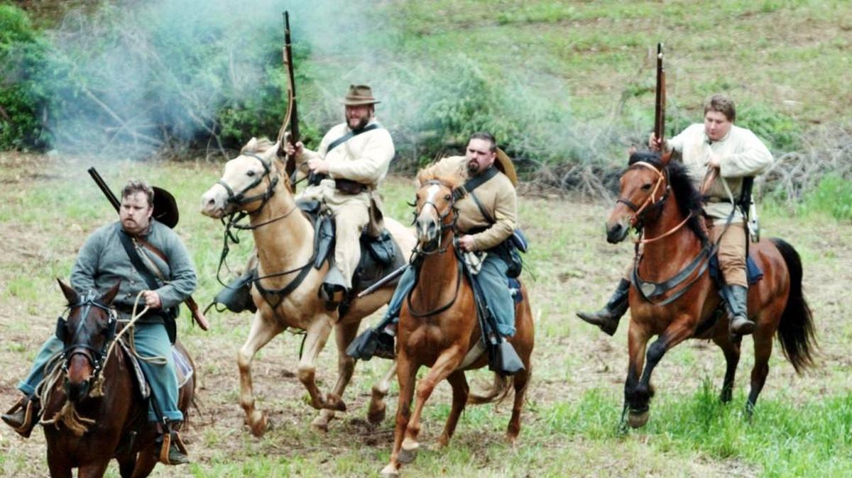 Confederate calvary re-enactors are spooked by musket discharges at the Old Clinton War Days in this file photo.