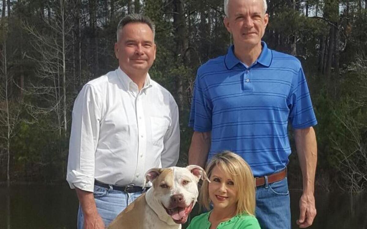 Clockwise from top left, Dr. George McCommon, Jeff Battcher, Patti Deeb Jones and AC Pup pose for a photo outside the Georgia Industrial Children’s Home.