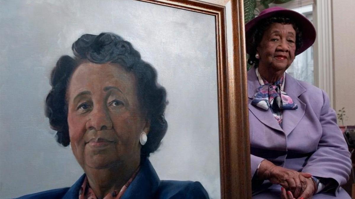 Dorothy Height sits next to a painting of herself in Washington in this 1997 file photo. )