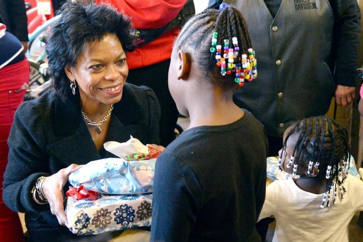 Anita Ponder hands out gifts to children during the annual Anita Ponder and Friends Holiday Feast.