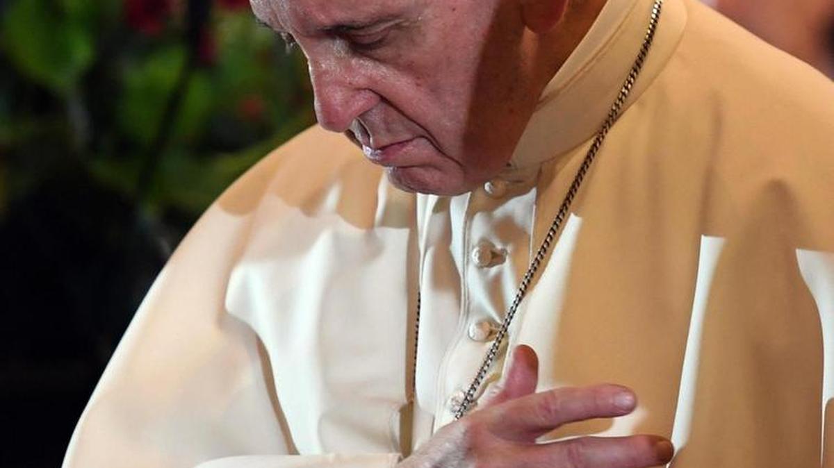 Pope Francis prays Wednesday in the Wawel Cathedral in Krakow, Poland.