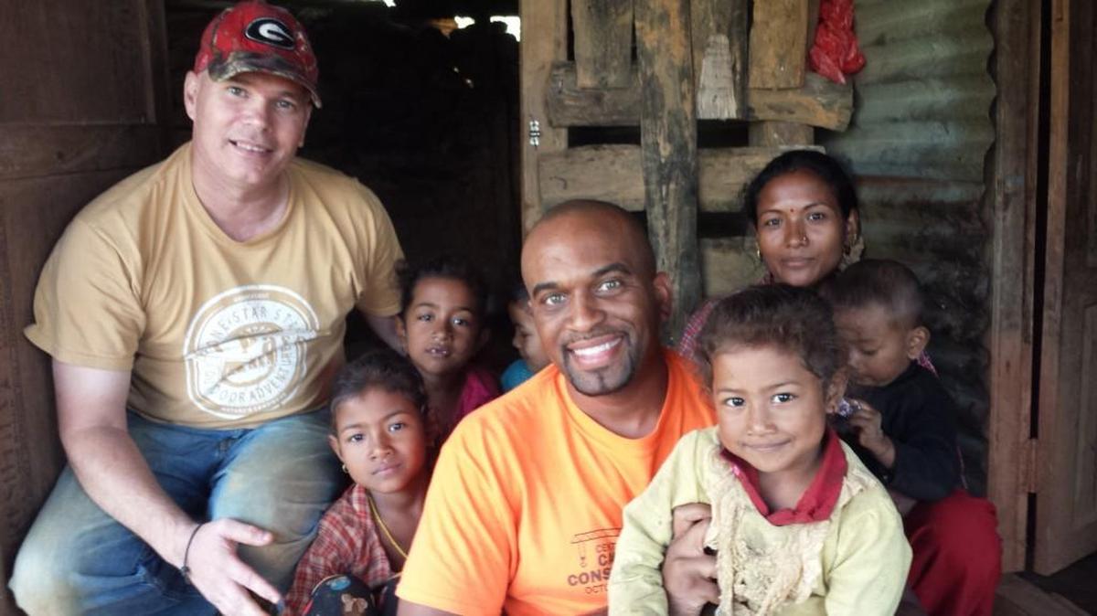 Robbie Parks and Walter Stafford take a break to visit with a homeowner and some children in the village where they did construction work during a mission trip to Nepal with Ingleside Baptist Church in November 2015.