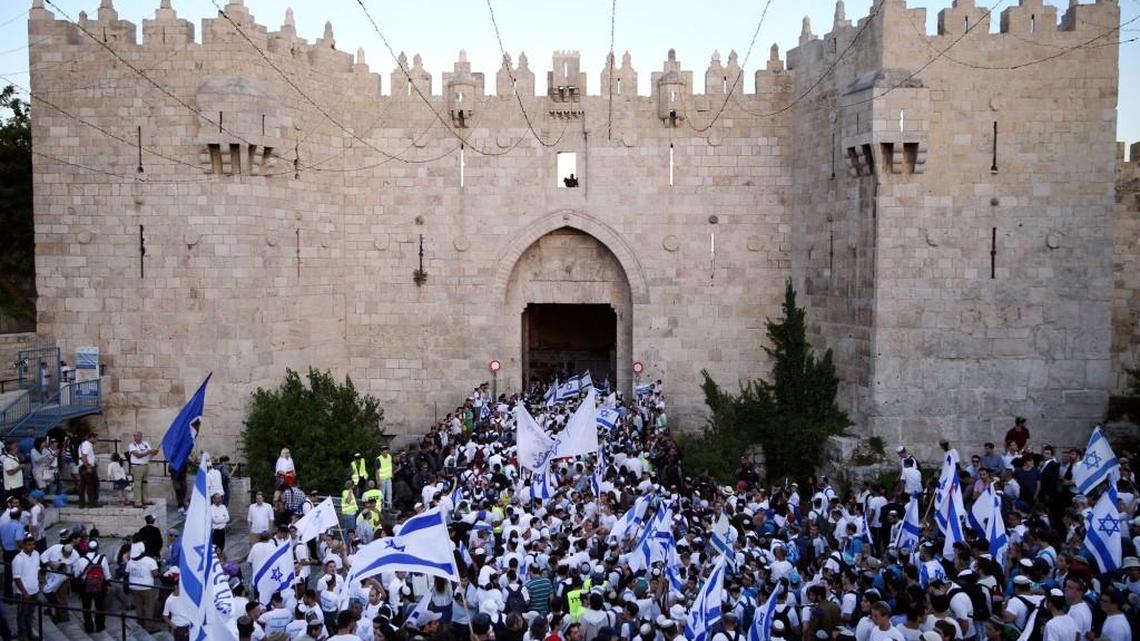 Israelis wave national flags outside the Old City’s Damascus Gate in Jerusalem on May 24 during Jerusalem Day, which marks the 50th anniversary of Israel’s capture of the city’s eastern half from Jordanian control during the Six-Day War in 1967.