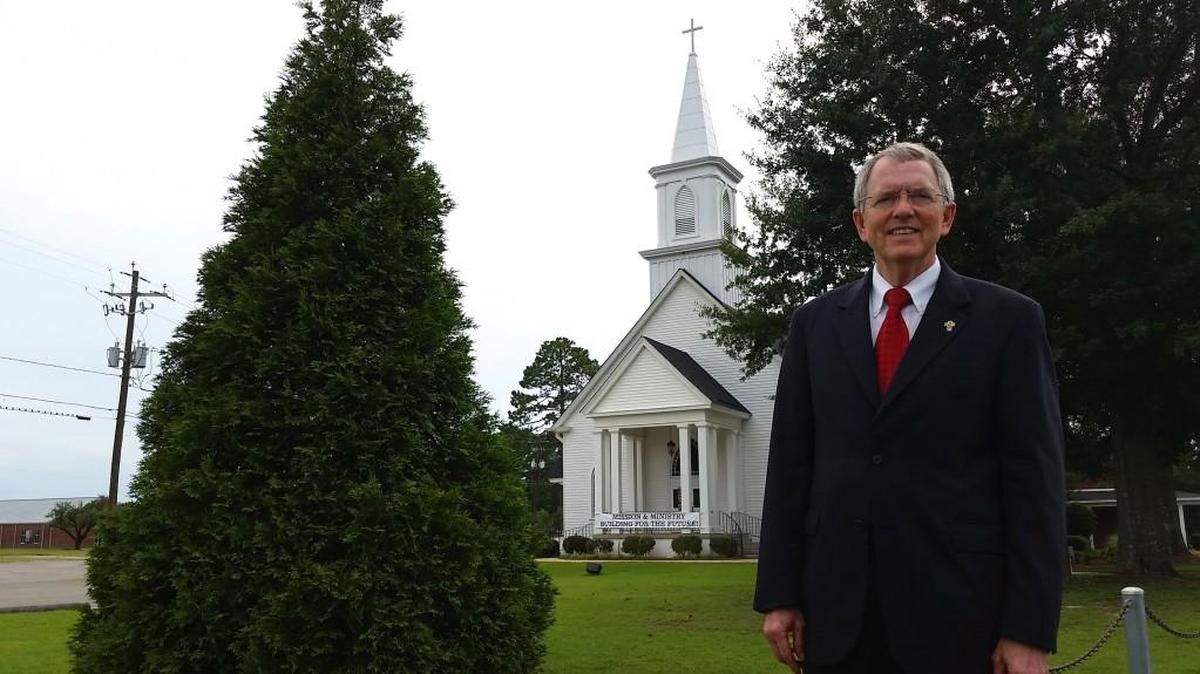 The Rev. Wayne Anthony is pictured in front of the white, steepled Liberty United Methodist Church building at 6511 Houston Road.