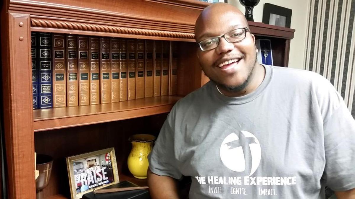 Chris Carter, of The Healing Experience Ministries, stands in front of volumes of John Wesley’s journals and sermons, which Carter said provide inspiration and set an example for him.