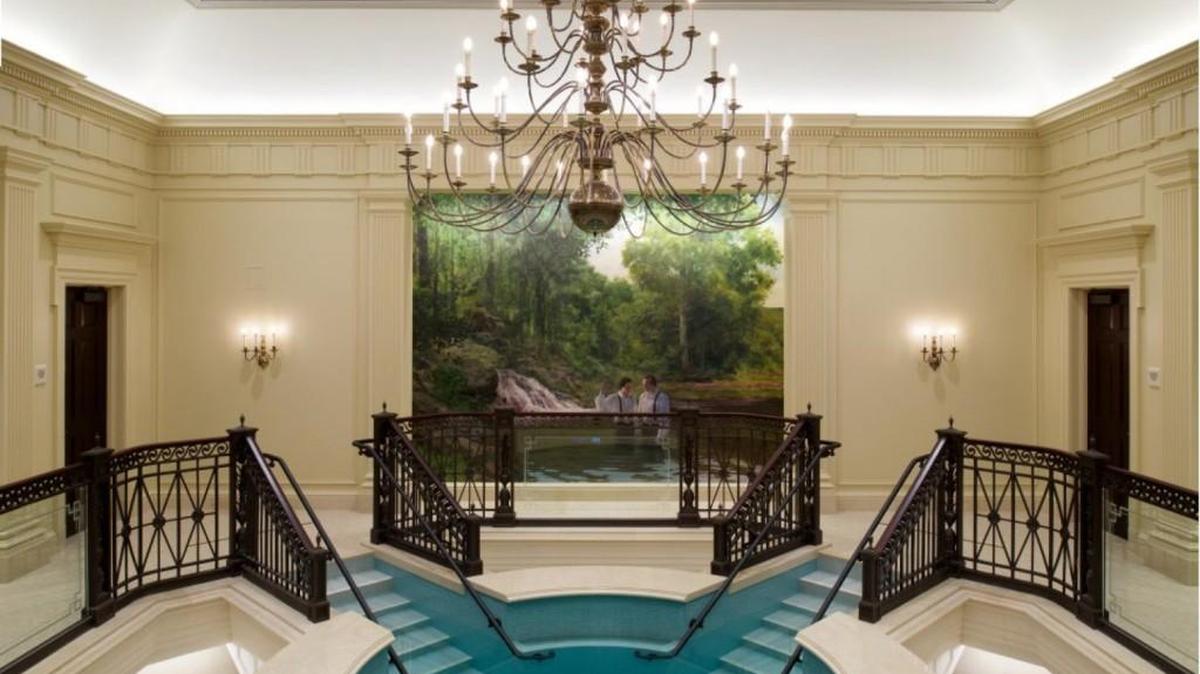 The Baptismal font inside the new Mormon Temple rests on the backs of 12 bronze oxen, which represent the 12 tribes of ancient Israel. The mural behind depicts the church's founder, Joseph Smith, being baptized in the Susquehanna River.