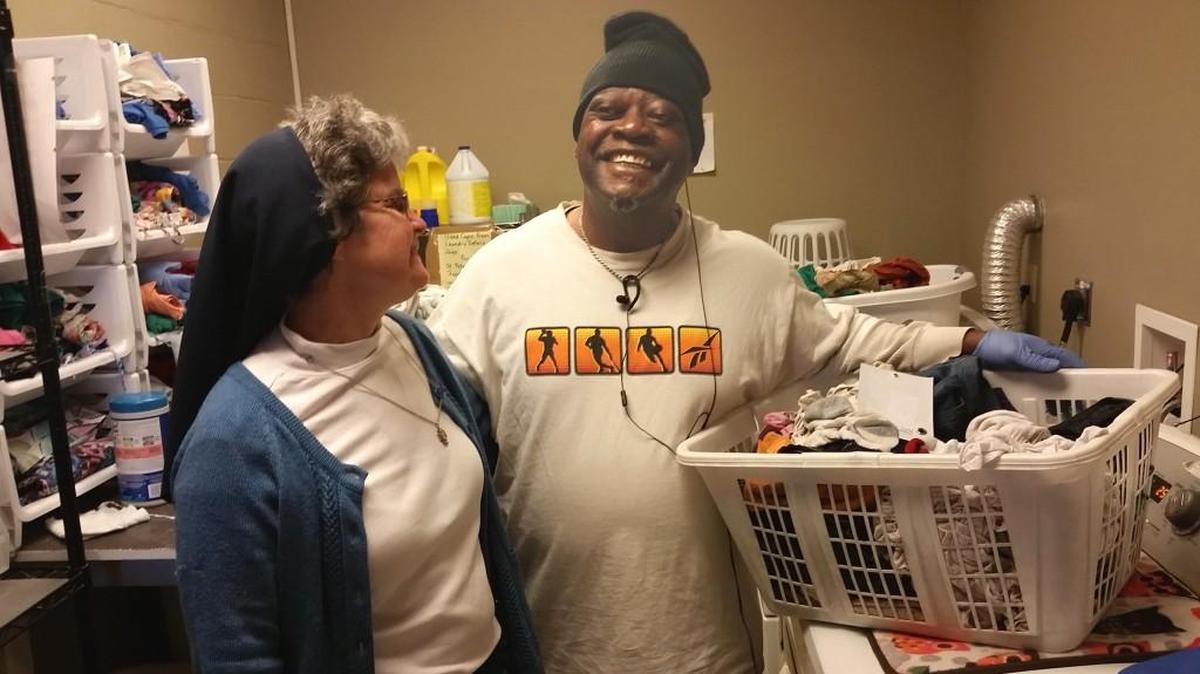 Sister Theresa Sullivan talks with Daybreak volunteer Craig Holland, who originally came to the center when illness and lost work forced him to live homeless. Daybreak and other area services helped him survive, get well and get back on his feet in a home.