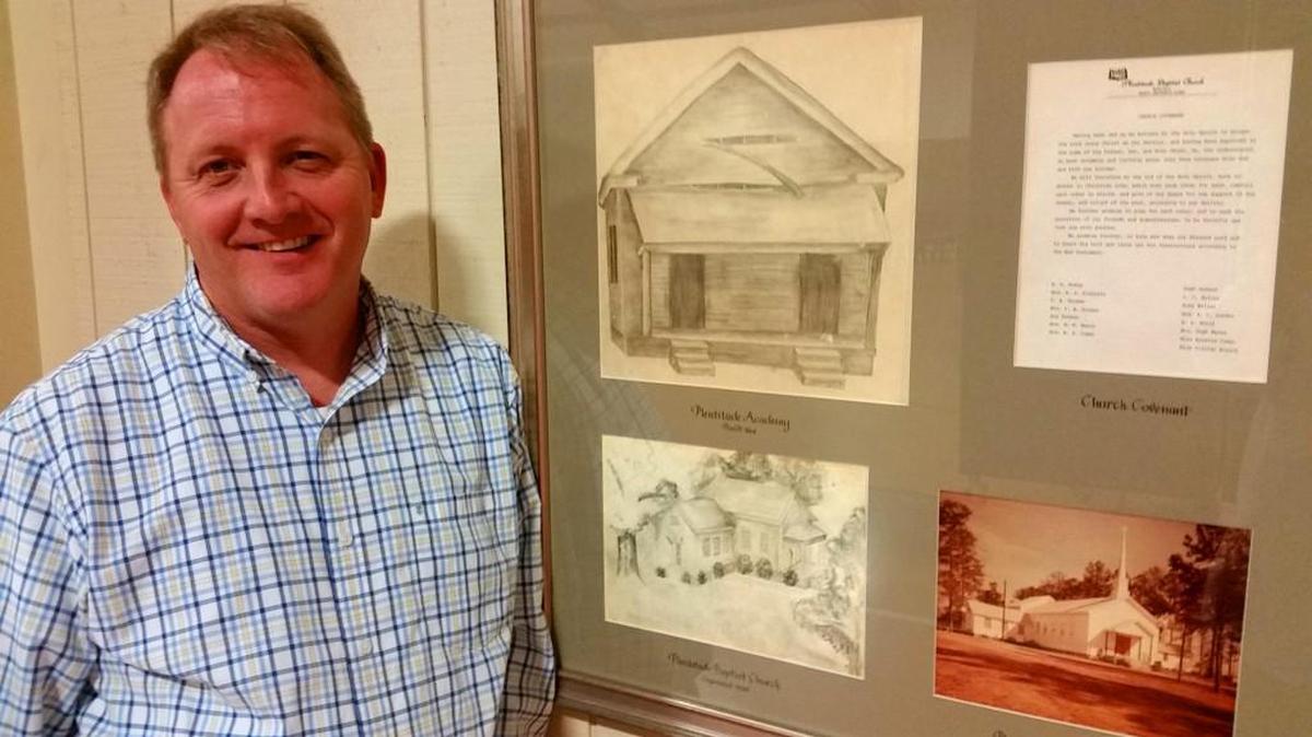 Pastor Tommy Freeman of Plentitude Baptist Church with a display of drawings, pictures and documents from the church’s rich history.