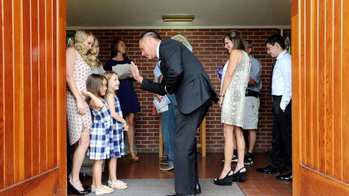 Associate pastor Michael Jones asks for a high five from a young member of the congregation at Heritage at Bass United Methodist Church on Sept. 4.