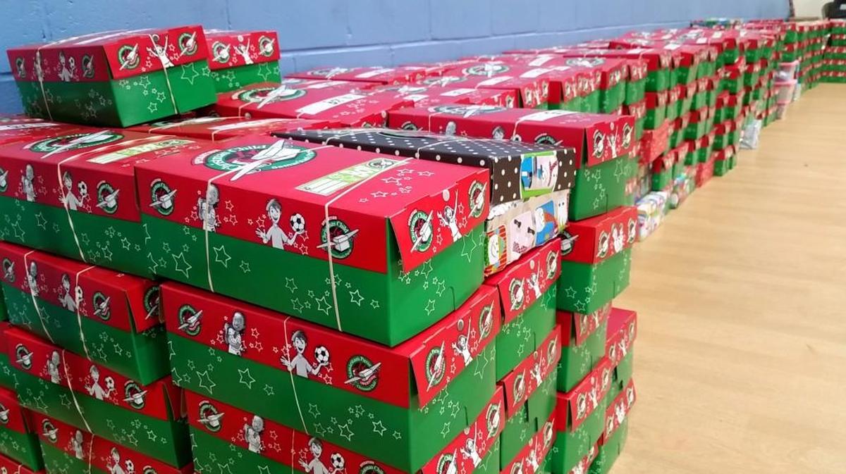 Operation Christmas Child gift boxes begin to stack up along a wall at Pine Forest Baptist Church.