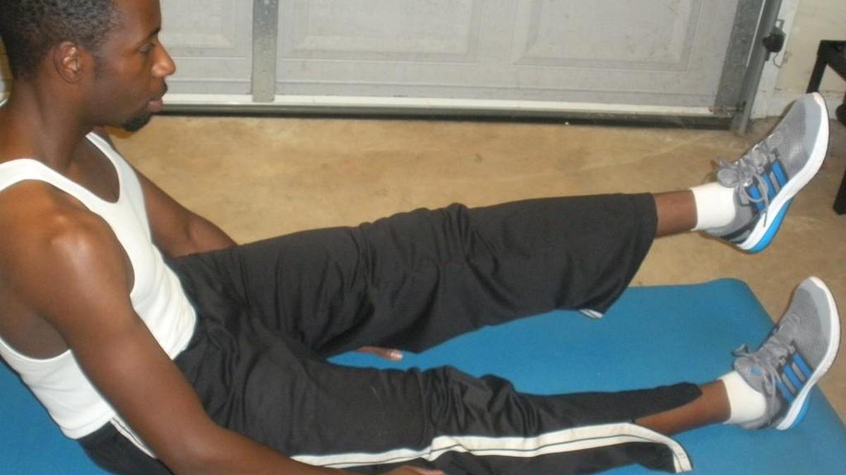 Shawn McClendon demonstrates a seated leg lift, which can be used to strengthen the muscles around the knee.