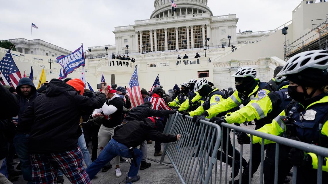 People try to break through a police barrier in Washington, D.C., on Jan. 6, 2021.