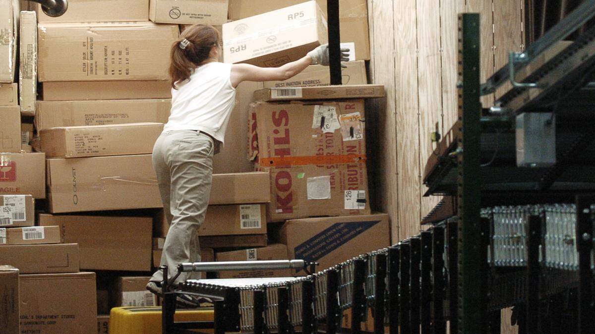 Boxes come off a conveyor system at Kohl's Macon distribution center as a worker loads a tractor-trailer headed to a store in this 2009 file photo. 
