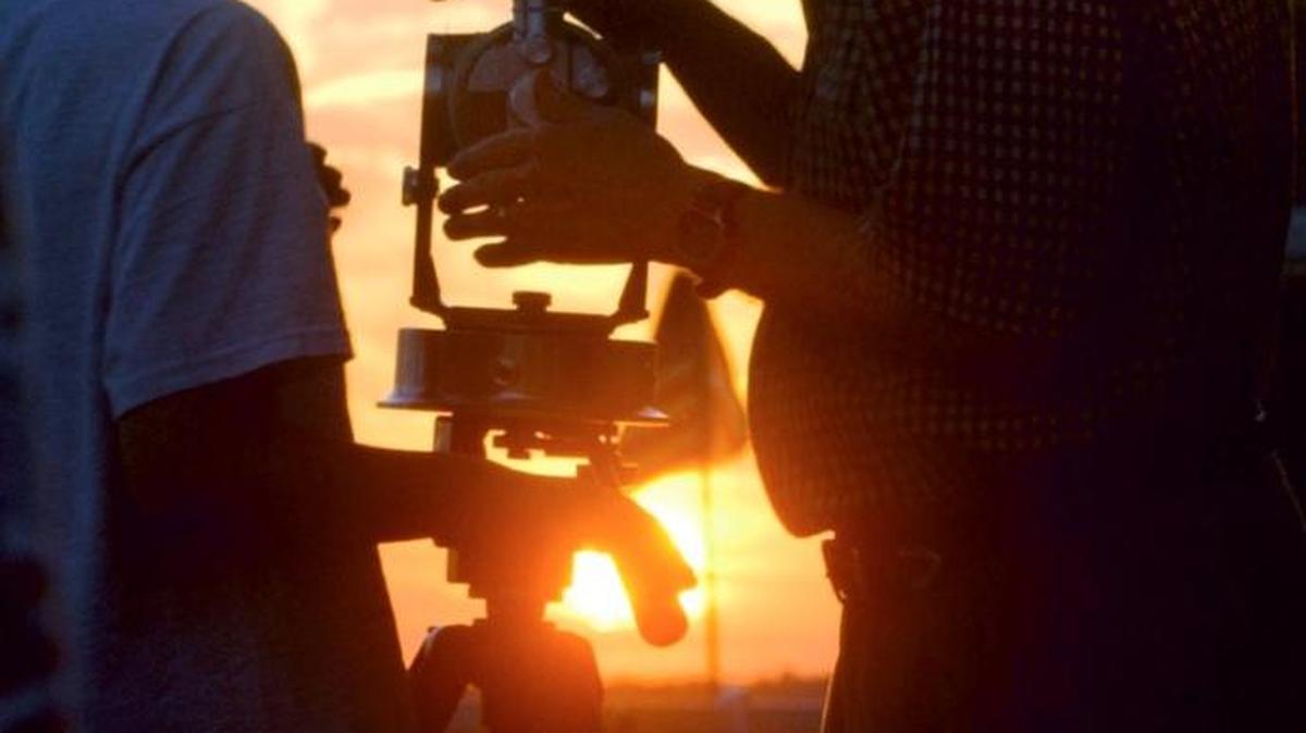 In this file photo, Macon astronomer Bob Coke, right, sets up a telescope for viewing the partial solar eclipse in 2002. Residents of Pinegate, which is said to be the highest point in Macon, watched the sunset — and the eclipse — from their backyards.