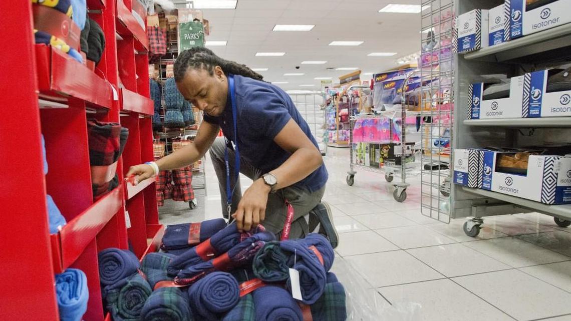 Kohl's hardline associate Trey Hill stocks a men's pajama display Nov. 23, 2016, in preparation for the store's Thanksgiving weekend sales. Kohl's opens at 6 p.m. Thanksgiving Day.