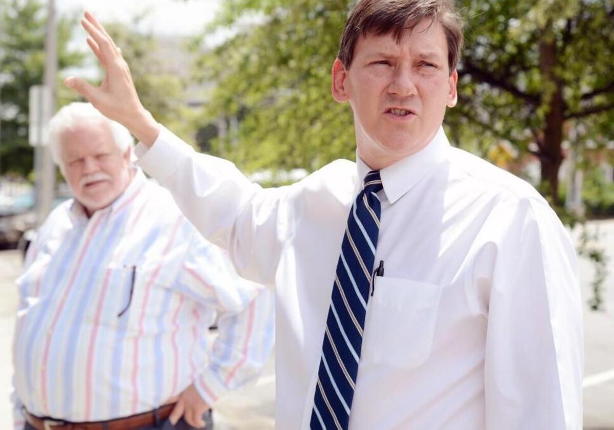 Developers Miller L. Heath, III and Tim Thornton talk with a reporter at the corner of 1st and Poplar Streets in May 2015 when they announced plans for a mixed-use development between 1st and 2nd streets and Poplar and Plum streets in downtown Macon.