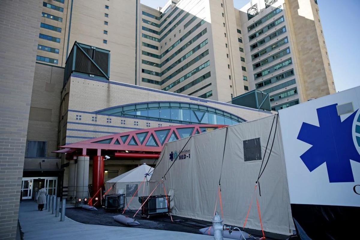 A mobile emergency room is set up outside Grady Memorial Hospital to help handle the ever-growing number of flu cases in Atlanta, Monday, Jan. 29, 2018. The trailer, called Carolinas MED-1, has 14 beds and will sit outside the hospital's main emergency room for 30 days to alleviate wait times and bed shortages. (AP Photo/David Goldman)