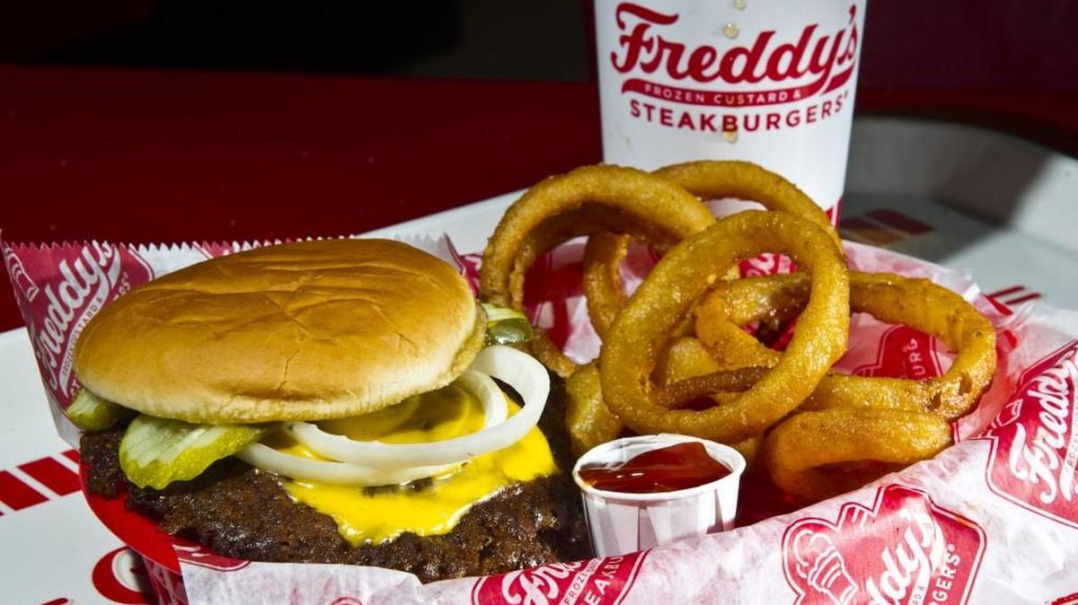 The Freddy's original double cheese with onion rings and a drink from Freddy's Frozen Custard and Steakburgers.