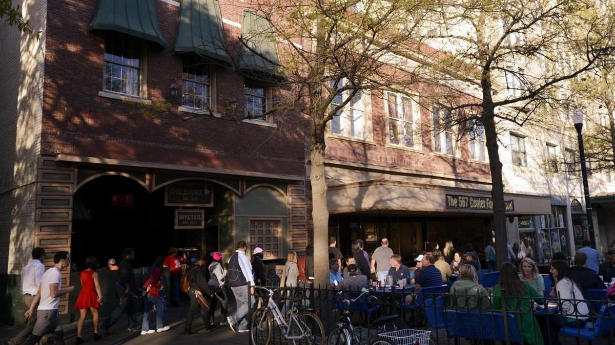 Visitors walk down Cherry Street past The Rookery Tavern during First Friday in April 2013.